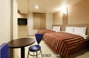 Letto o letti in una camera di Hua Xiang Motel - Arena