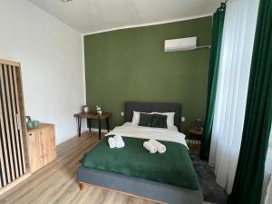a bedroom with a bed with towels on it at Homeland Center Cluj in Cluj-Napoca