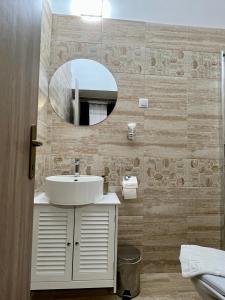 a bathroom with a sink and a mirror at Homeland Center Cluj in Cluj-Napoca