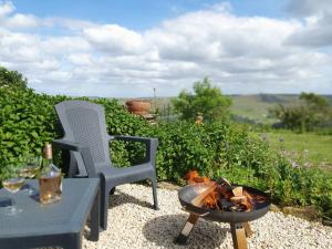a fire pit next to a chair and a table at The Studio at Stoodley Pike View in Todmorden