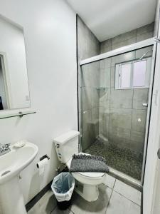 a bathroom with a shower and a toilet and a sink at Casa Ambar in Tijuana