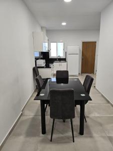 einen schwarzen Esstisch und Stühle in der Küche in der Unterkunft La Meridian II in Barcelona