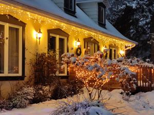 a house decorated with christmas lights in the snow at La Tremblante in Mont-Tremblant