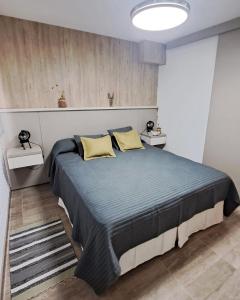 a bedroom with a large bed with two yellow pillows at Aldea Mate Amargo in Potrero de Garay +158 photos
