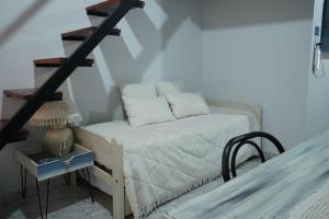 a bedroom with a bed and a stair case at La Casa de Sol in Posadas