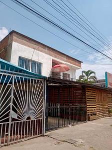 a building with an iron gate with a balcony with an umbrella at Acogedor apartamento moderno para 6 personas in Cali