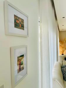 a living room with two pictures on the wall at Nicocreon Guest House in Famagusta