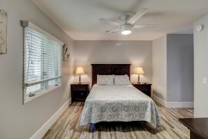 a bedroom with a bed and a ceiling fan at Luxury Updated 6 BR home Private Pool Near Ocean Bikes & Beach Gear Included in Hilton Head Island +31 photos