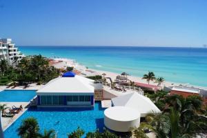 an aerial view of the beach and the pool at the resort at Beachfront Resort Studio with Romantic Sunset Views in Cancún