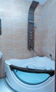 a bath tub in a bathroom with a sink at Epson’s Villas in Brufut