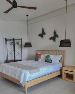 a bedroom with a bed with butterflies on the wall at Serenity Terraces Beach, Hotel - Kokrobite in Kokrobite