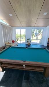 a pool table in the middle of a living room at Aldea Mate Amargo in Potrero de Garay