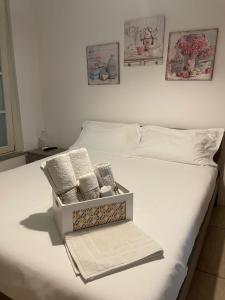 a bed with two boxes of towels on it at Aury & Ester Casa Vacanze in Crema
