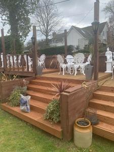 a wooden deck with white chairs and tables at The Swan Inn Salisbury in Wilton