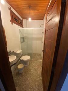 a small bathroom with a toilet and a sink at Maceió Kite House in Camocim