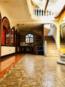 a large room with a staircase and a stone floor at Mi casa es tu casa in San Pedro La Laguna