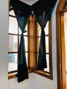 a window with colorful curtains in a room at Mi casa es tu casa in San Pedro La Laguna