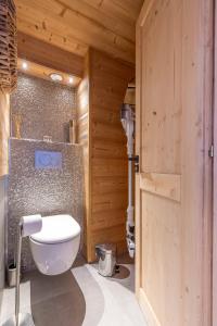 a bathroom with a toilet in a wooden room at Val Thorens - Cosy Duplex avec Vue Pied des pistes Silveralp 570 in Val Thorens