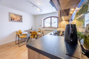 a kitchen with a stove and a table and chairs at U Majerczyka Dolina Apartment in Zakopane