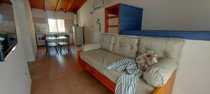 a couch with a teddy bear sitting on it in a kitchen at Las Grutas Star in Las Grutas