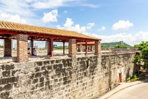 a stone wall with a building on top of it at Apartamento en Centro Histórico De Cartagena in Cartagena de Indias