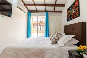 Säng eller sängar i ett rum på Apartamento en Centro Histórico De Cartagena