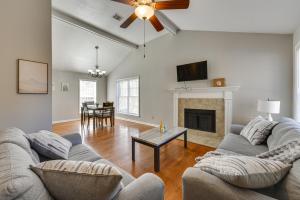a living room with a couch and a fireplace at Baton Rouge Condo with Balcony, Fireplace and Pool! in Baton Rouge