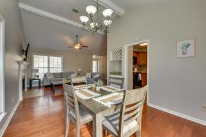 a dining room and living room with a table and chairs at Baton Rouge Condo with Balcony, Fireplace and Pool! in Baton Rouge