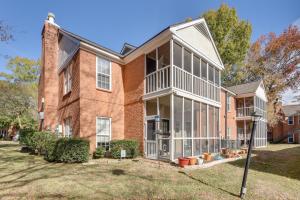 an exterior view of a brick house with windows at Baton Rouge Condo with Balcony, Fireplace and Pool! in Baton Rouge