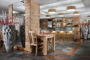 a dining room with a wooden table and chairs at Apartamenty przy Hotelu Żywieckim in Przyłęków