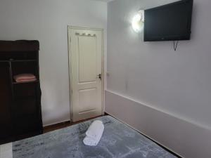 a room with a door and a white object on the floor at Captain Morgan House in Arona
