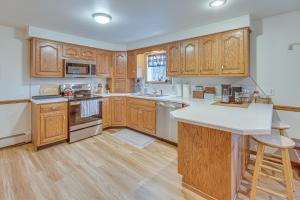 a kitchen with wooden cabinets and a white counter top at Tranquil Mt Pleasant Mills Retreat on 60-Acre Farm in Dalmatia