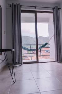 a room with a large window with a view of a building at Aires de Altura y Singani in Tarija