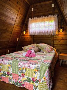 a small bedroom with a bed in a attic at Chalé de Madeira em Vargem Alta in Vargem Alta