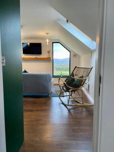 a living room with a chair and a couch at Bill's Barns Apartment 2 in Kenmare