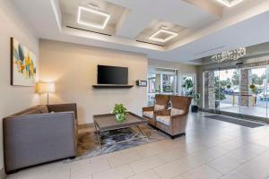 a living room with a couch and a tv at Best Western Canoga Park Motor Inn in Canoga Park