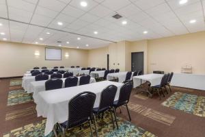 a conference room with tables and chairs and a screen at Best Western St. Louis Inn in Arnold