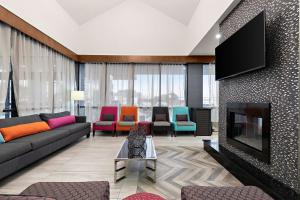 a living room with a couch and a tv at Best Western Plus Toronto North York Hotel & Suites in Toronto