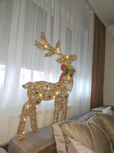 a illuminated statue of two reindeer with lights at Apartman Tajna in Sremčica