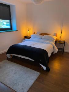 a bedroom with two beds and a flat screen tv at Bill's Barns, Apartment 1 in Kenmare