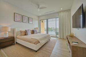 a bedroom with a bed and a table and a window at ONE Canal Point in Upper Land