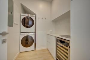 a kitchen with a washer and dryer in the wall at ONE Canal Point in Upper Land