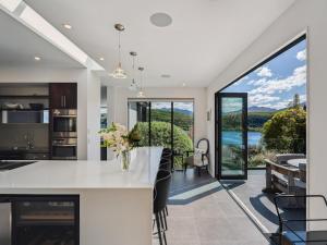 a kitchen with a white counter and a large window at Hawthorne House in Queenstown