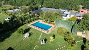 an aerial view of a house with a swimming pool at Cabañas de la Barra in Villarrica