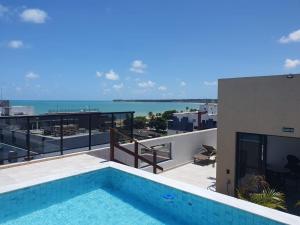 a swimming pool on the roof of a building at Apartamento 403 - Largo de Tambau in João Pessoa