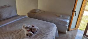 a hotel room with two beds and a mirror at Maloka lago de bachue in Villa de Leyva