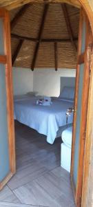 a bedroom with a bed in a wooden room at Maloka lago de bachue in Villa de Leyva