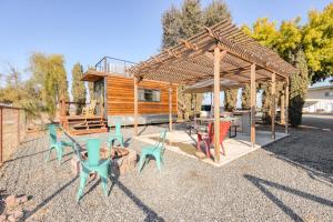 a group of chairs and tables under a pavilion at Tiny Cargo Home North in Tulare