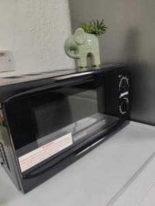 a microwave sitting on top of a counter at 1 bedroom flat in Neepsend