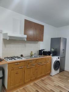 a kitchen with a sink and a stove and a dishwasher at 1 bedroom flat in Neepsend